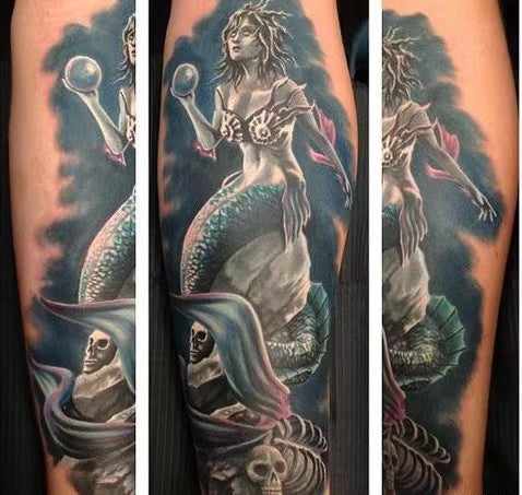 Tattoo myth-snake around the mermaid